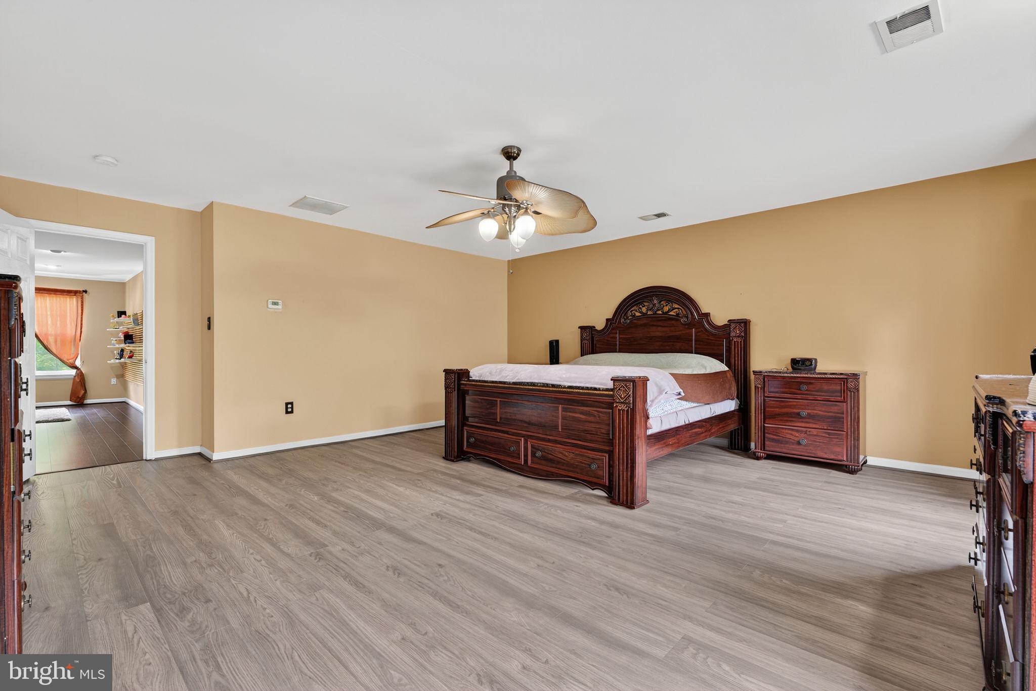 751 Holly Leaf Road Culpeper, VA 22701 - Photo 37 of 65 a bedroom with furniture and wooden floor