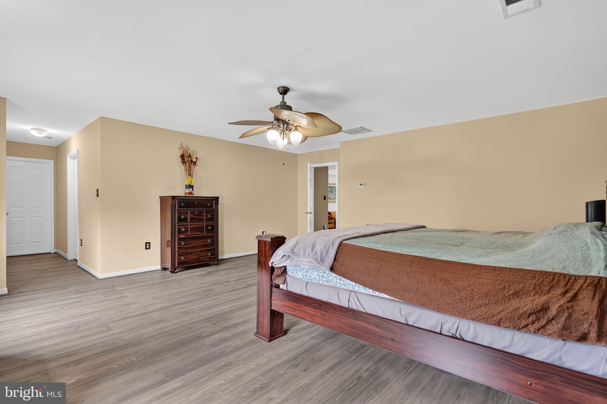 751 Holly Leaf Road Culpeper, VA 22701 - Photo 38 of 65 a bedroom with a bed and a chandelier