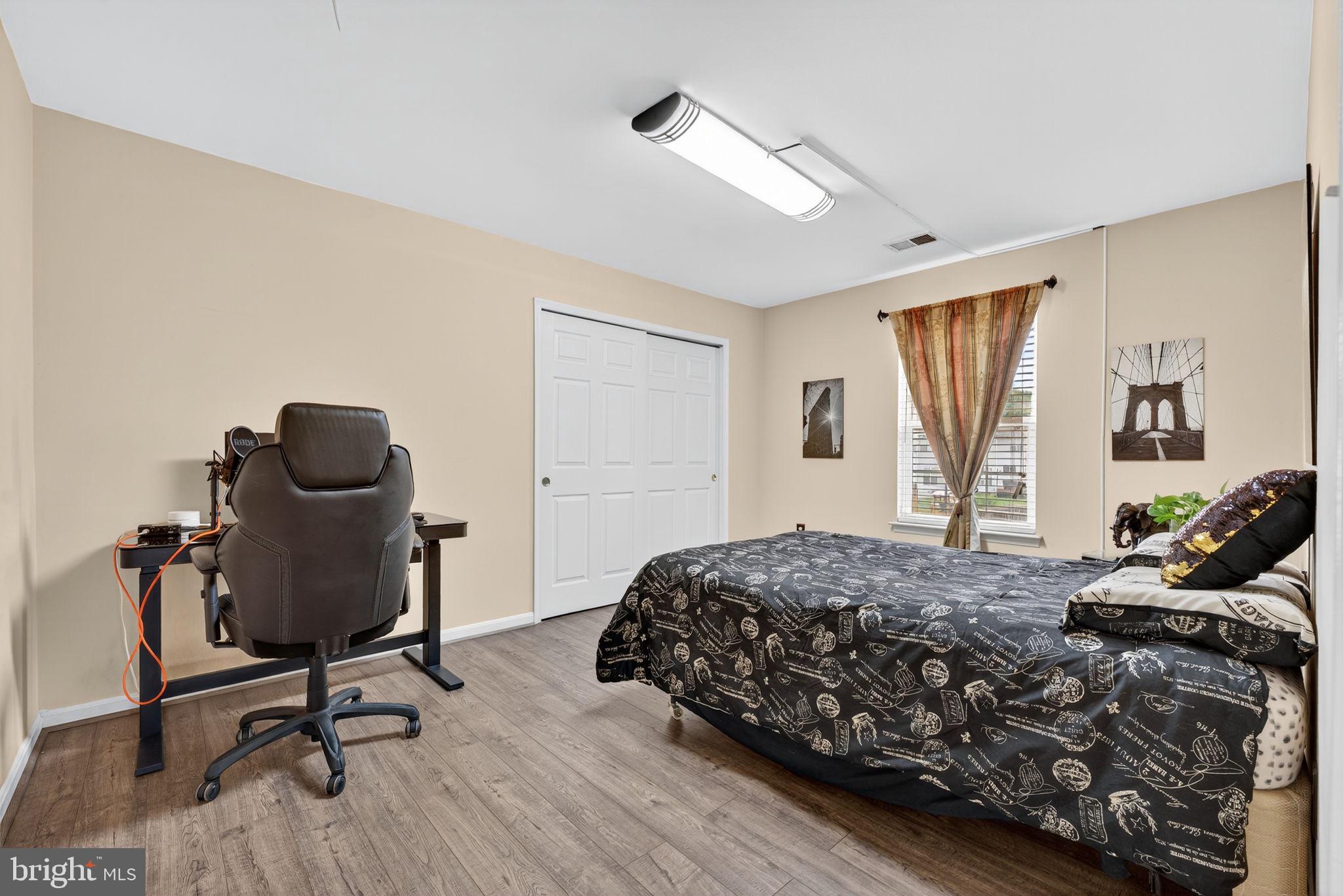 751 Holly Leaf Road Culpeper, VA 22701 - Photo 48 of 65 a bedroom with a bed and a chair