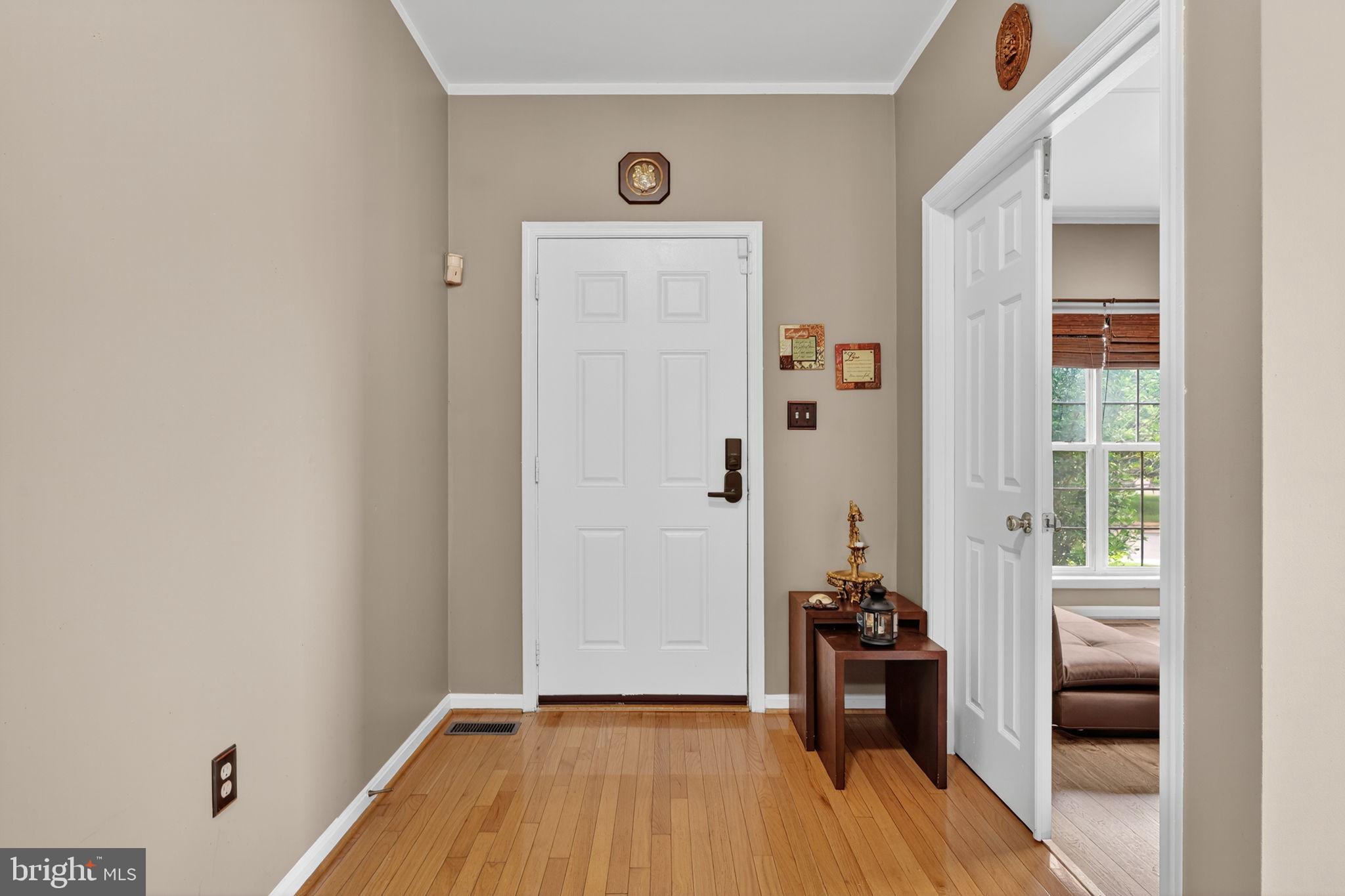 751 Holly Leaf Road Culpeper, VA 22701 - Photo 6 of 65 a view of a hallway with wooden floor and a bathroom