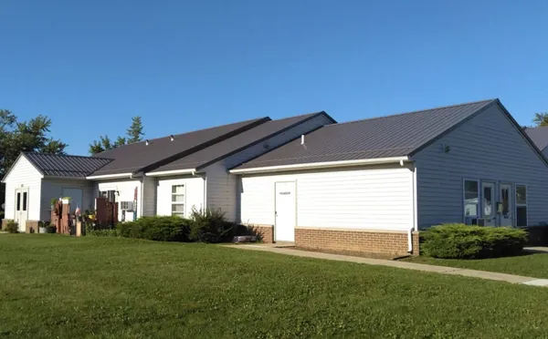 a front view of house with yard and outdoor seating