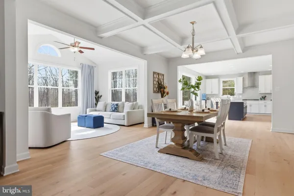 a kitchen with stainless steel appliances a table chairs sink refrigerator and microwave