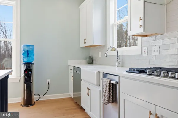 a spacious bathroom with a double vanity sink a toilet and a shower