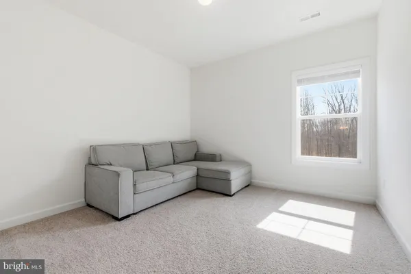 a bedroom with furniture and a potted plant