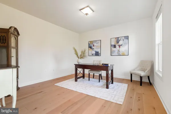 a dining room with wooden floor a chandelier a wooden table and chairs