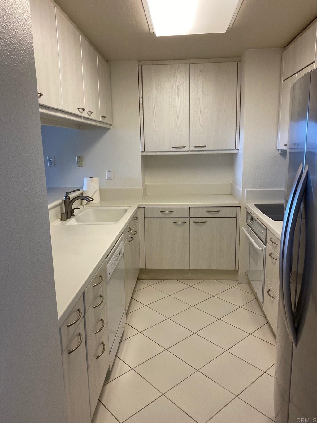 2500 Torrey Pines Road, Unit 1002 La Jolla, CA 92037 - Photo 3 of 8 a kitchen with granite countertop a sink a stove and cabinets