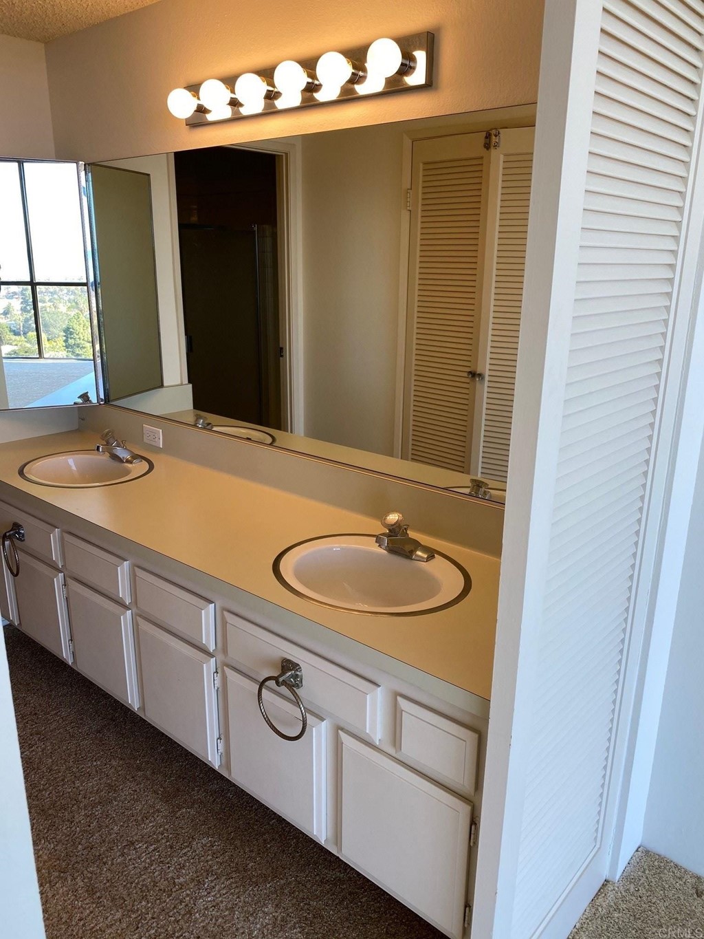 2500 Torrey Pines Road, Unit 1002 La Jolla, CA 92037 - Photo 5 of 8 a bathroom with a granite countertop sink and a mirror
