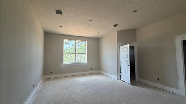 an empty room with a empty space and windows