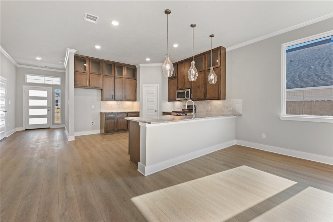 4245 Appalachian Trail Bryan, TX 77802 - Photo 11 of 30 a view of a kitchen with cabinets stainless steel appliances and wooden floor