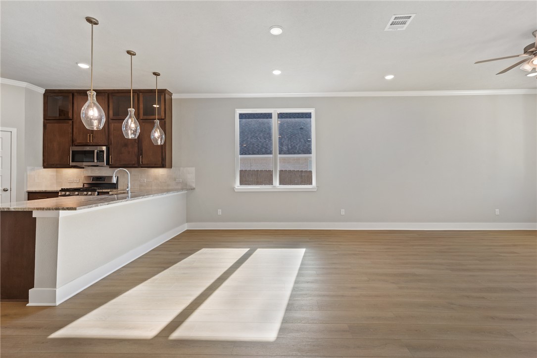 4245 Appalachian Trail Bryan, TX 77802 - Photo 15 of 30 a view of a kitchen with a sink and dishwasher with wooden floor