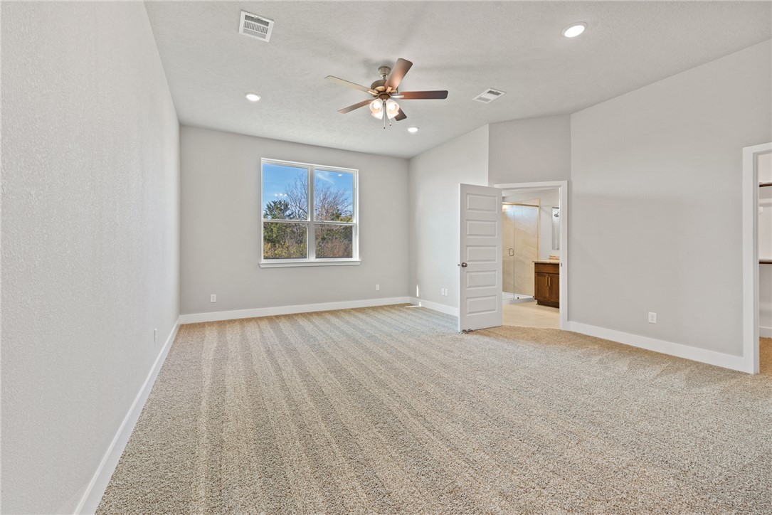 4245 Appalachian Trail Bryan, TX 77802 - Photo 21 of 30 an empty room with ceiling fan and window