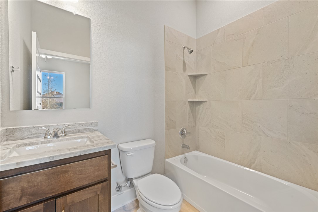4245 Appalachian Trail Bryan, TX 77802 - Photo 7 of 30 a bathroom with a toilet a sink and bathtub