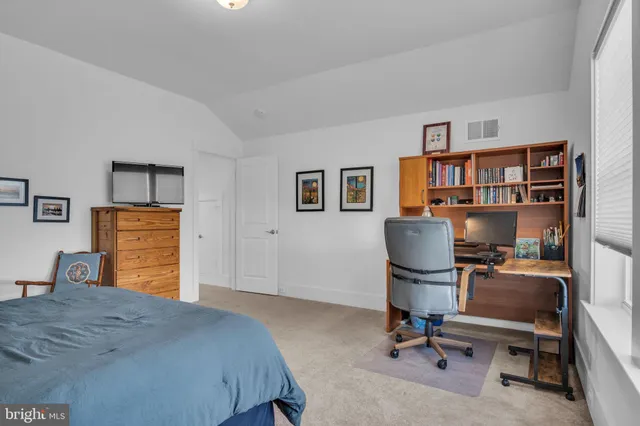 a front view of a house with a garden and plants
