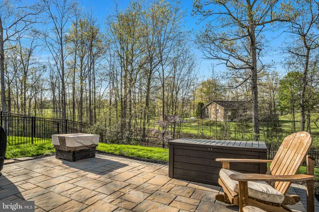 a view of a house with pool and chairs