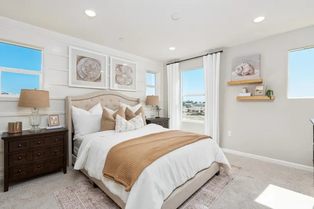 a bedroom with a bed and painting on the wall