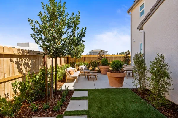 a outdoor living space with furniture potted plant and a large window