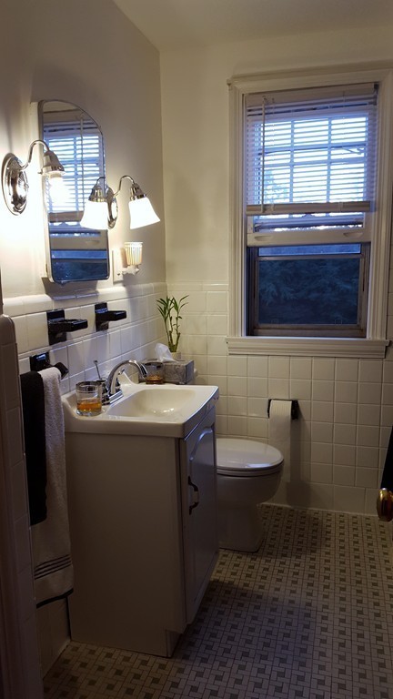 112 Oregon Street Springfield, MA 01118 - Photo 3 of 7 a bathroom with a sink and a mirror