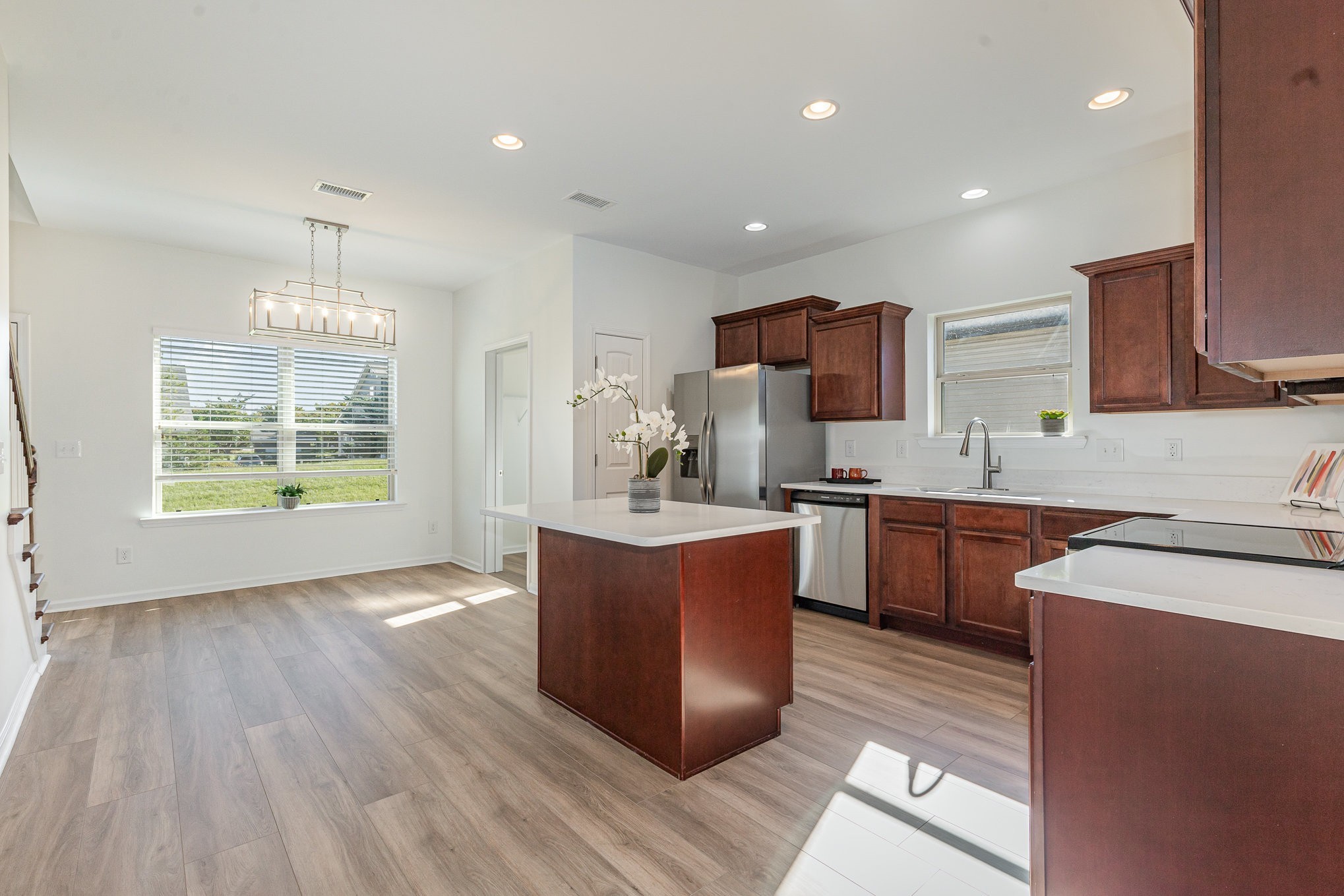 1087 Achiever Circle Spring Hill, TN 37174 - Photo 11 of 39 a large kitchen with stainless steel appliances granite countertop a stove a sink dishwasher and a oven with wooden floors