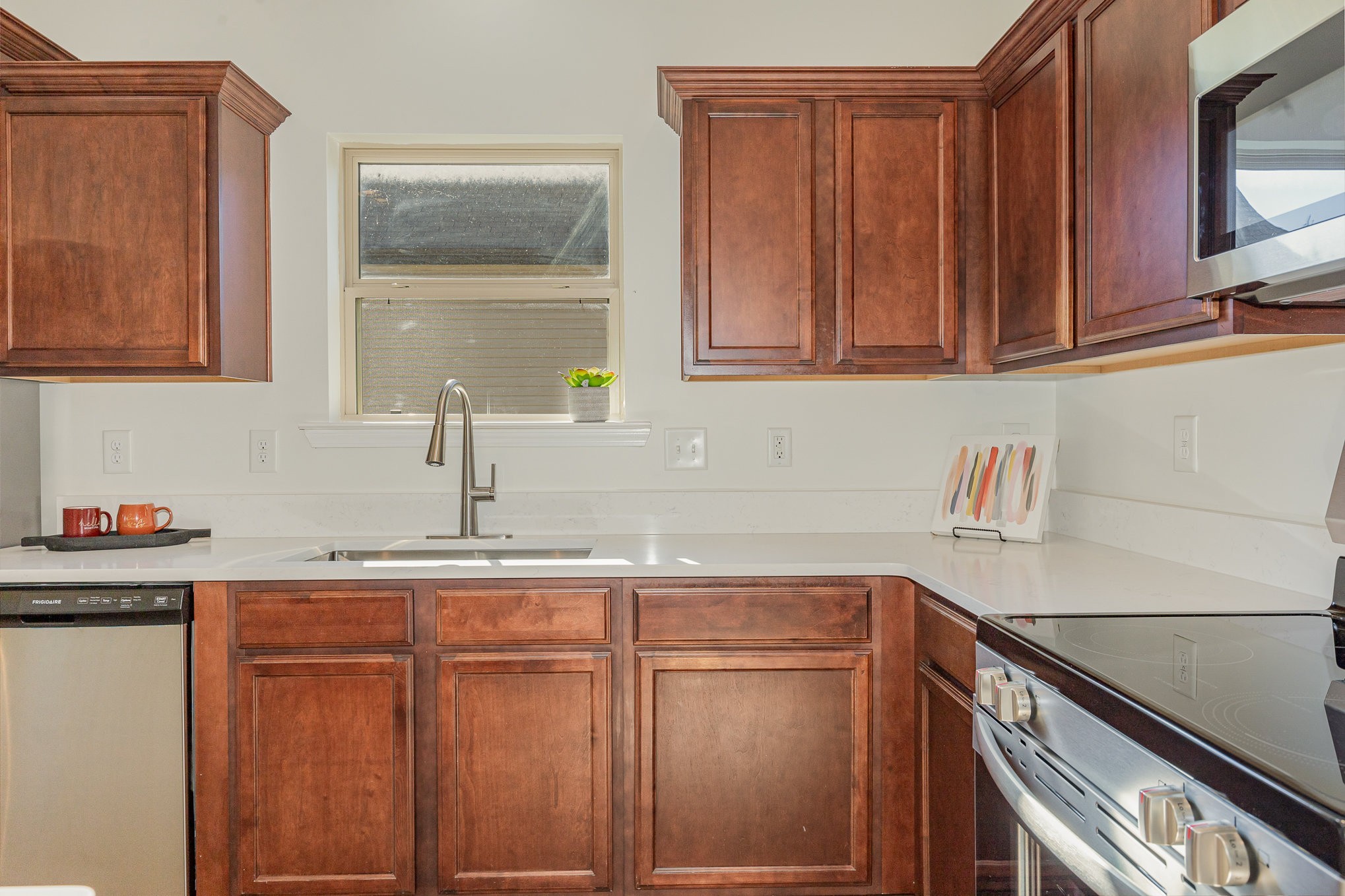 1087 Achiever Circle Spring Hill, TN 37174 - Photo 13 of 39 a kitchen with granite countertop wood cabinets and a sink