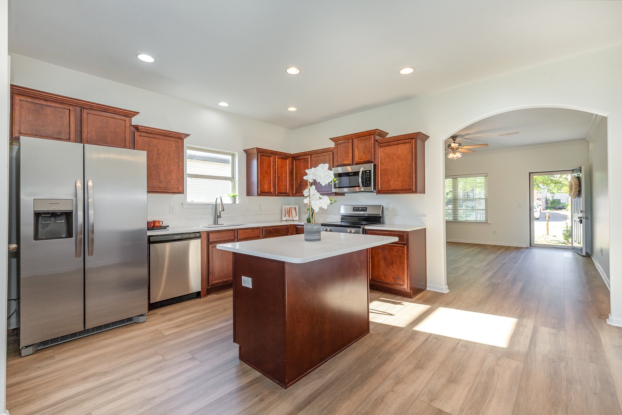 1087 Achiever Circle Spring Hill, TN 37174 - Photo 14 of 39 a kitchen with stainless steel appliances granite countertop a refrigerator a sink dishwasher a stove and a wooden floors