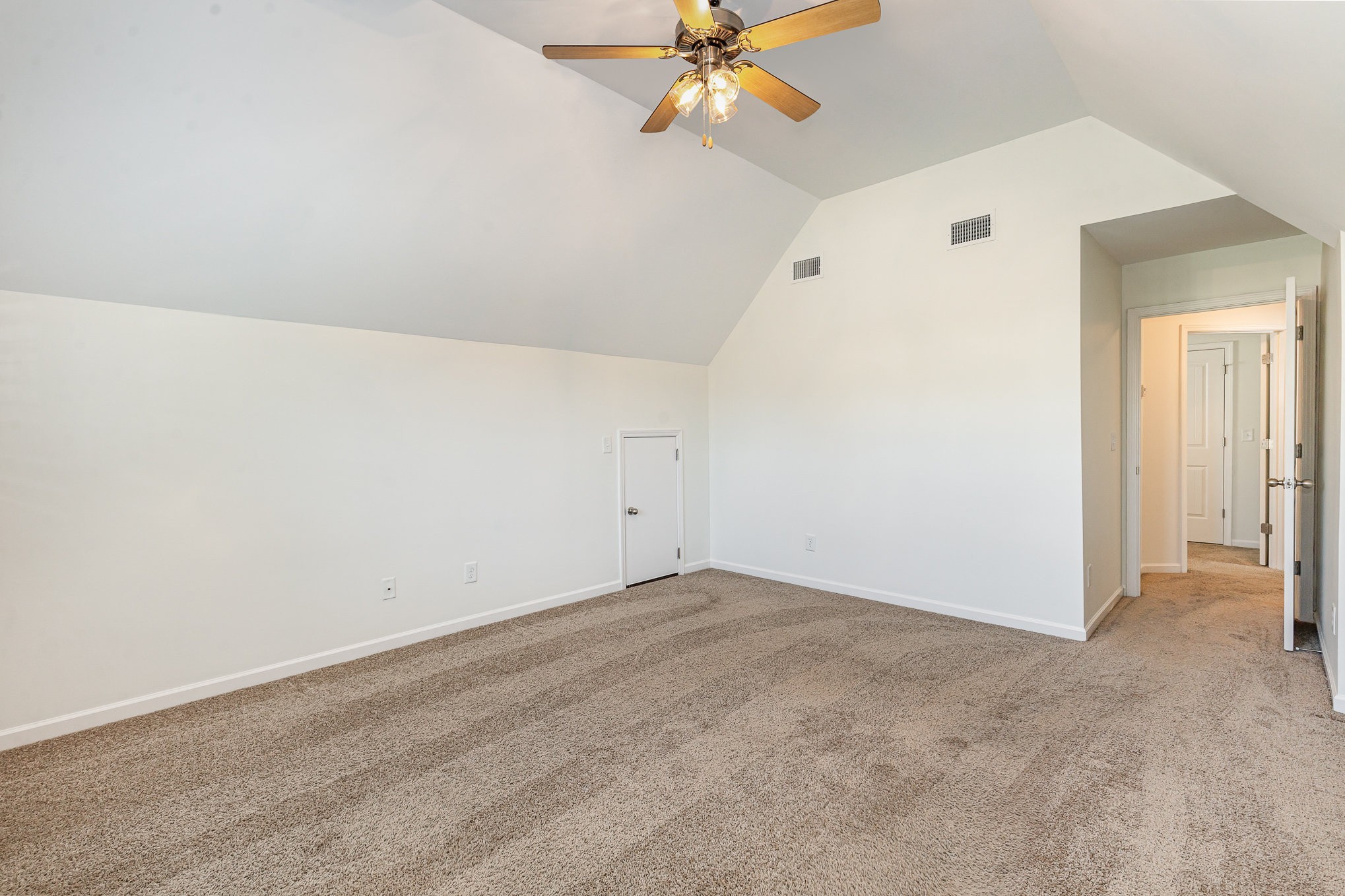 1087 Achiever Circle Spring Hill, TN 37174 - Photo 31 of 39 an empty room with closet and a chandelier fan