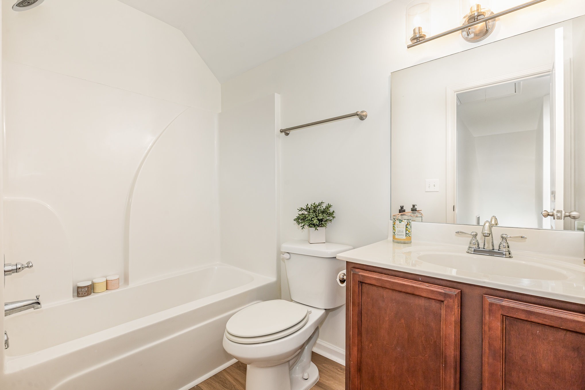 1087 Achiever Circle Spring Hill, TN 37174 - Photo 34 of 39 a bathroom with a bathtub shower sink vanity mirror and toilet