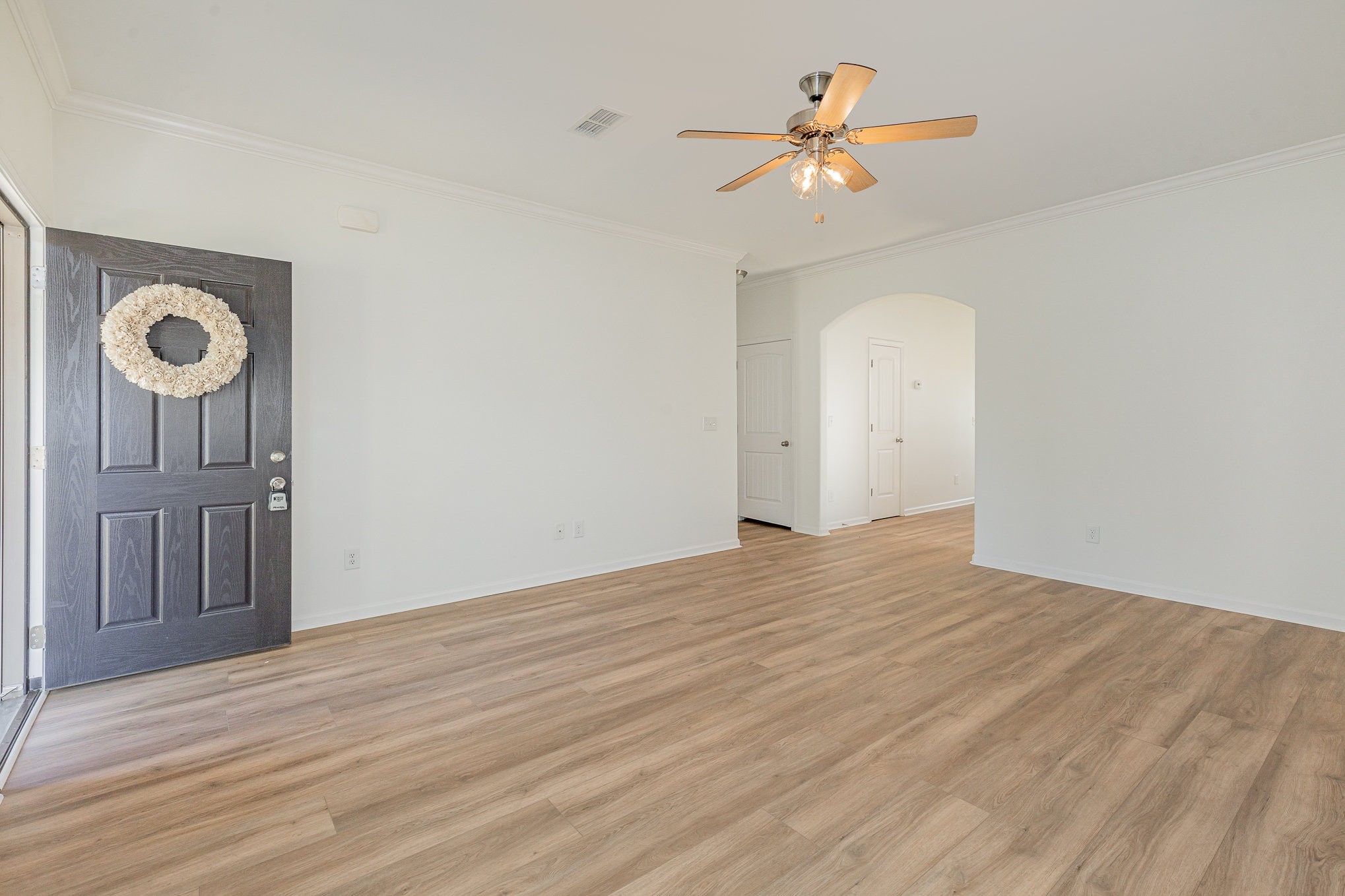 1087 Achiever Circle Spring Hill, TN 37174 - Photo 8 of 39 a view of a room with wooden floor and a ceiling fan