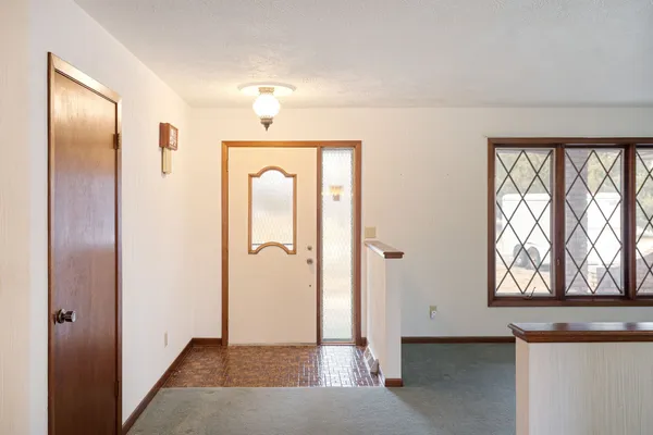 a view of entryway with window and wooden floor