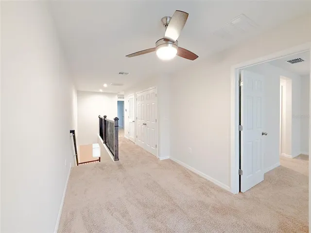 a view of a livingroom with a furniture and a ceiling fan