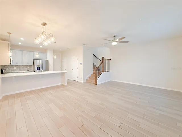 a view of a kitchen with furniture and a ceiling fan