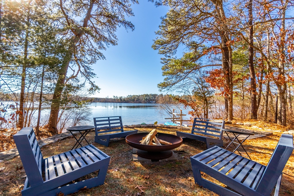 a view of a patio with lawn chairs and a fire pit