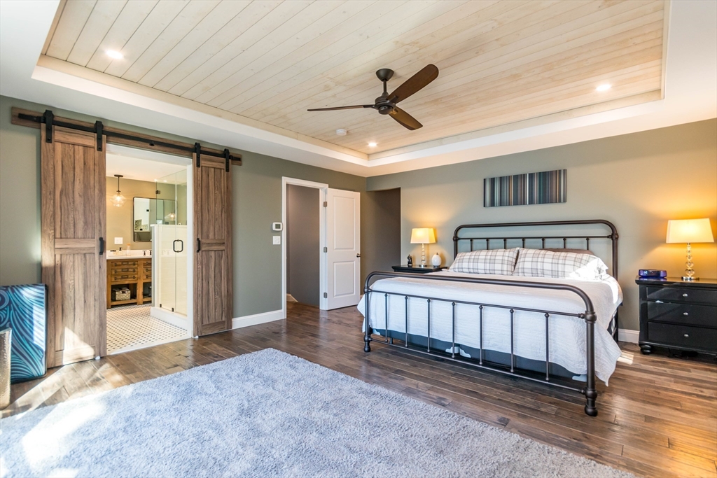 2 Blackmore Pond Circle Wareham, MA 02576 - Photo 20 of 42 a bedroom with a bed and a chandelier