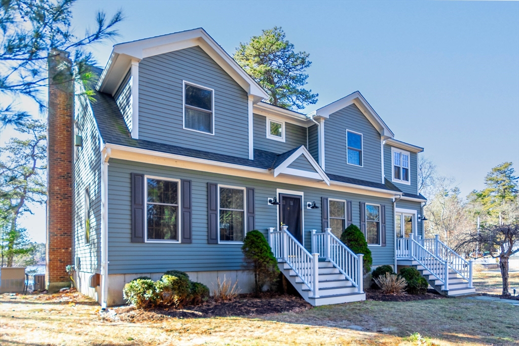 2 Blackmore Pond Circle Wareham, MA 02576 - Photo 2 of 42 a front view of a house with a yard