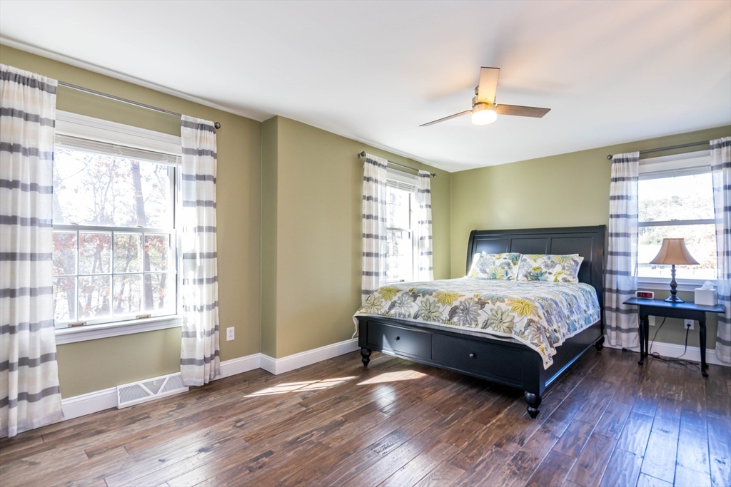 2 Blackmore Pond Circle Wareham, MA 02576 - Photo 25 of 42 a large bedroom with a bed and wooden floor