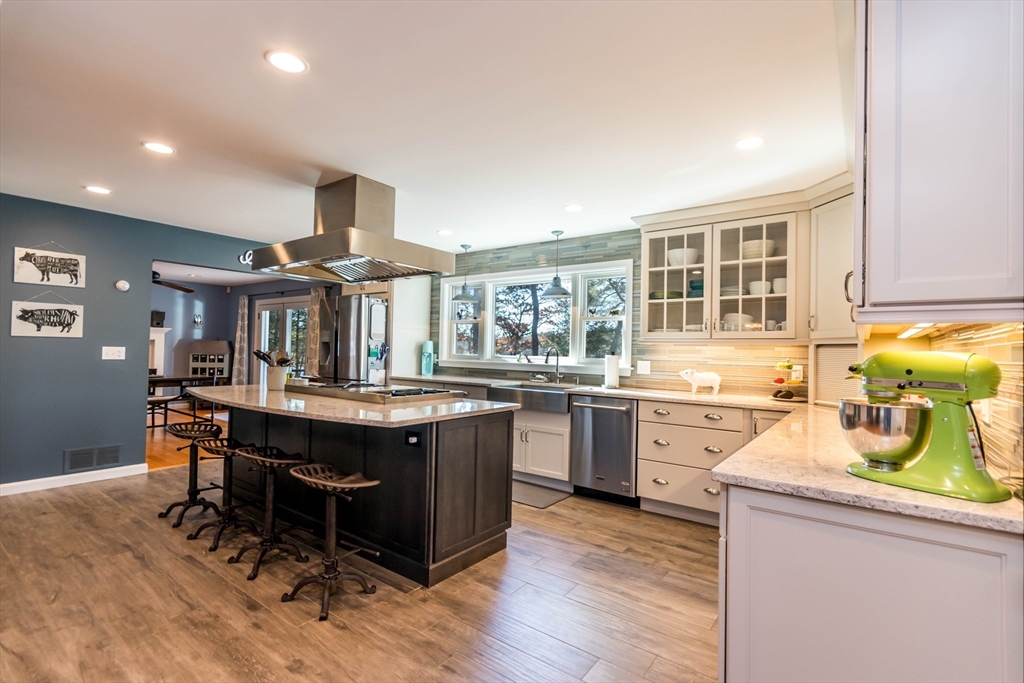 2 Blackmore Pond Circle Wareham, MA 02576 - Photo 6 of 42 a kitchen with a sink stove and wooden cabinets