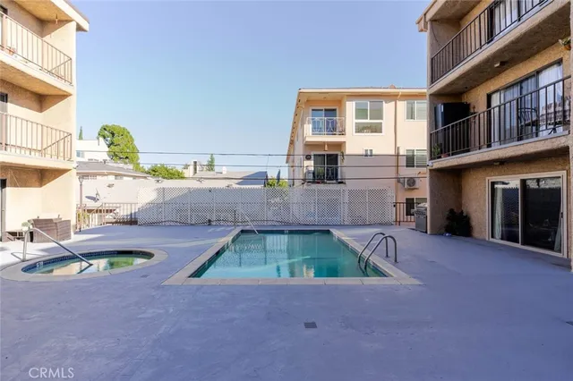 a view of a house with swimming pool in front of it
