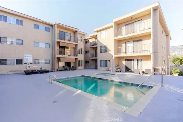 a front view of a building with a garden