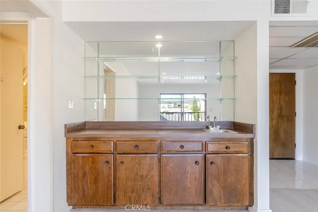a bathroom with a chandelier fan and windows