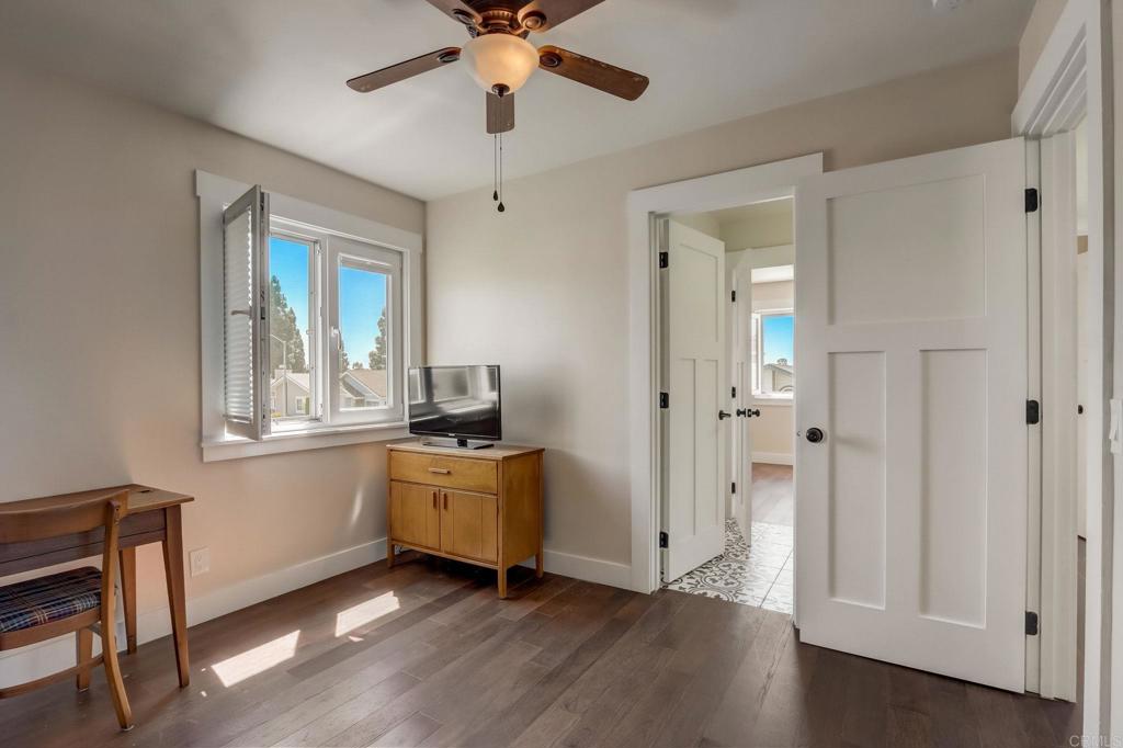 2035 Waterbury Chula Vista, CA 91913 - Photo 15 of 26 an empty room with wooden floor windows and a chandelier fan