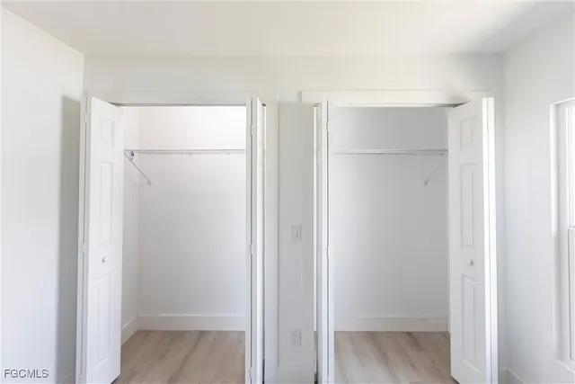 a view of walk in closet with wooden floor