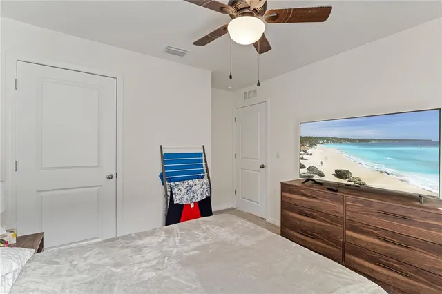 a room that has a dresser and a chandelier