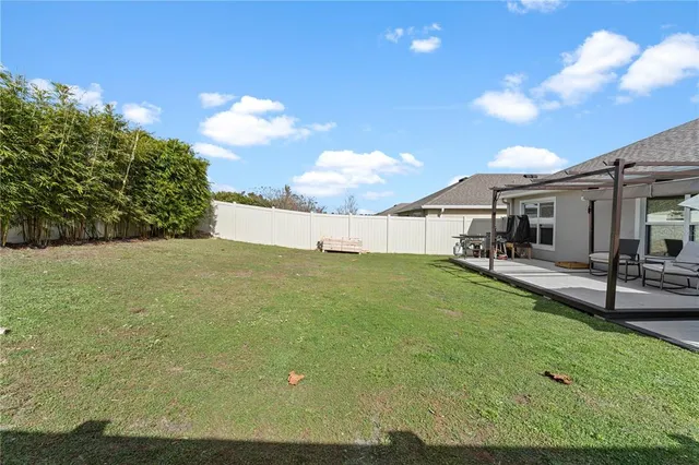 a view of a house with a backyard