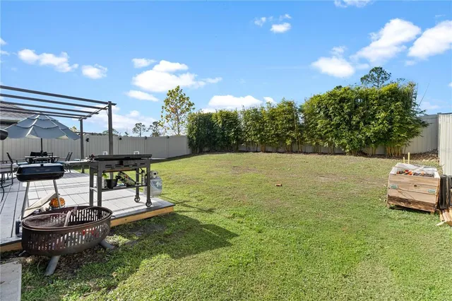 a backyard of a house with table and chairs