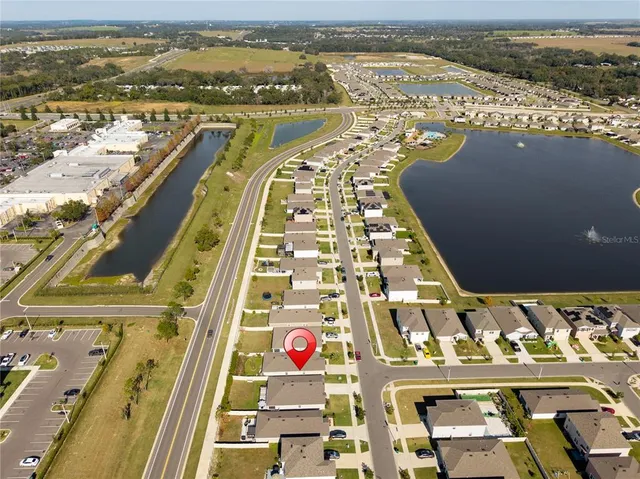 an aerial view of residential building and lake