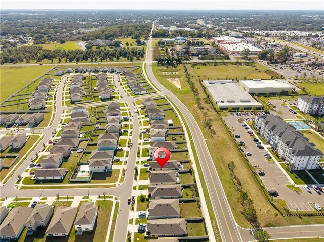 an aerial view of residential houses with outdoor space