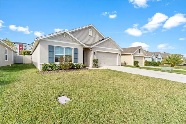a front view of a house with a garden and plants
