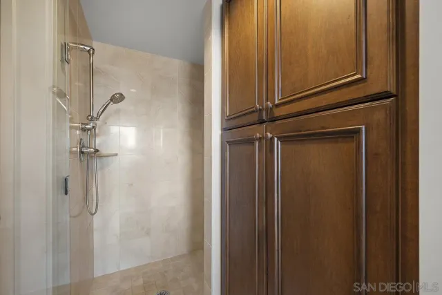 a view of a patio with table and chairs under an umbrella