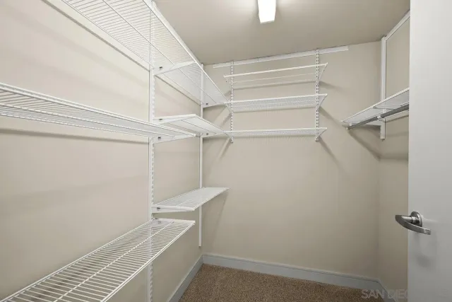 a dining room with furniture a wooden floor and a kitchen view