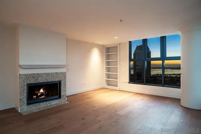 a view of empty room with window and fireplace