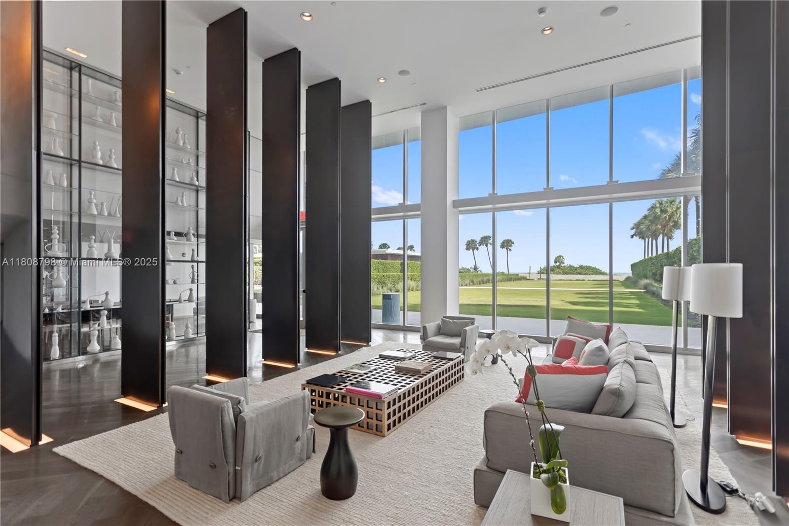 a living room with furniture and a floor to ceiling window